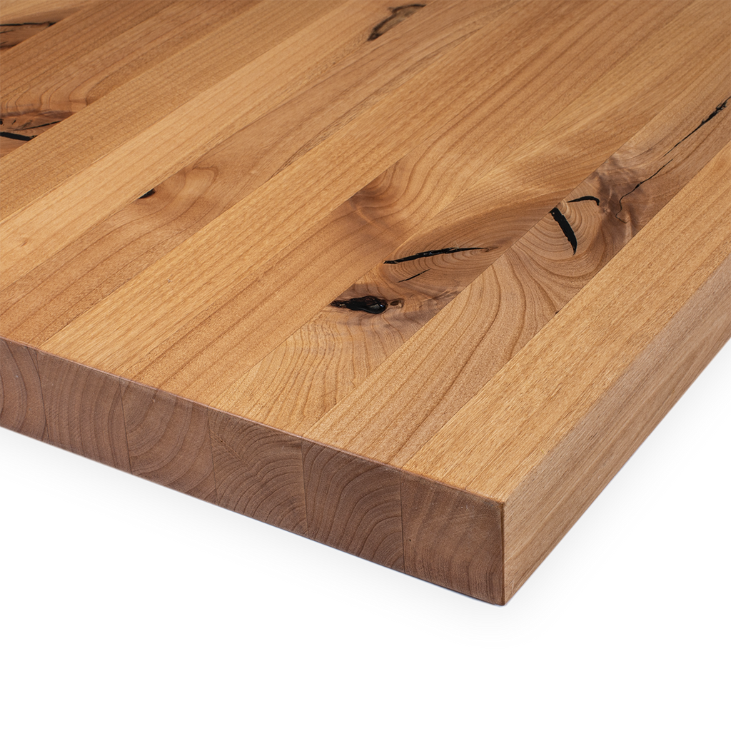 Image of the top and edges of corner of edge grain butcher block made of Knotty Alder wood. 
